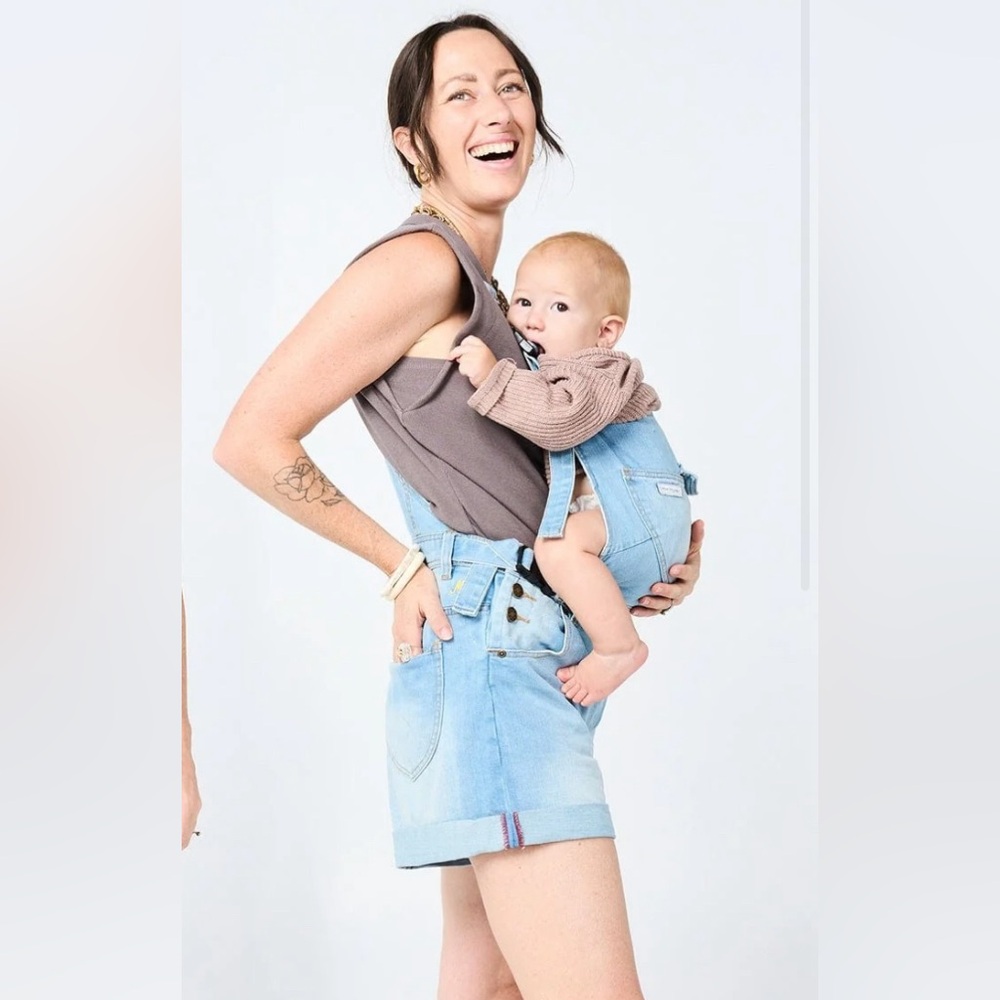 Mumsie baby wearing shortalls in light blue.